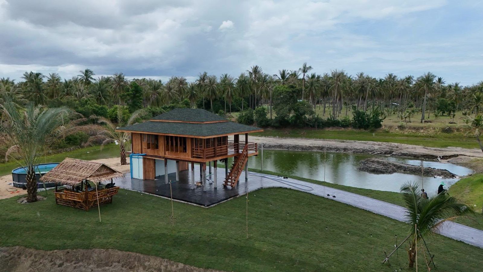 Aerial photograph of The Nine Beachclub & Resort beside the lagoon among coconut palms in Kui Buri, Thailand